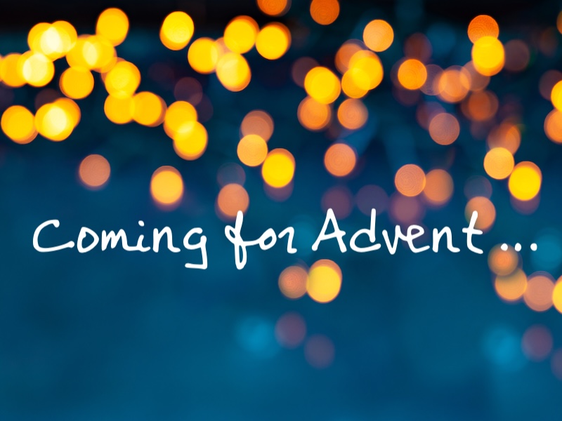 blue background with blurred points of light. handwritten text: "Coming for Advent ..."